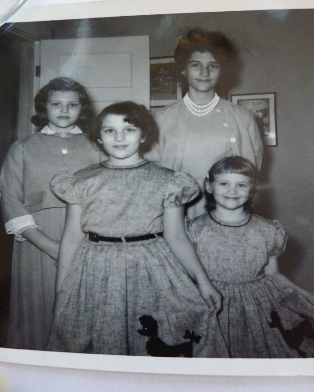 Me with my sisters - I am on the lower right showcasing the black poodle on my new dress